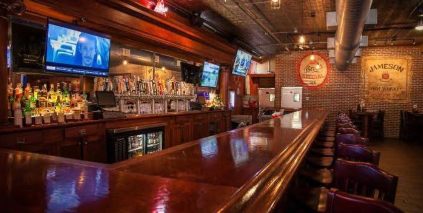Inside Irish bar with bar stools and televisions